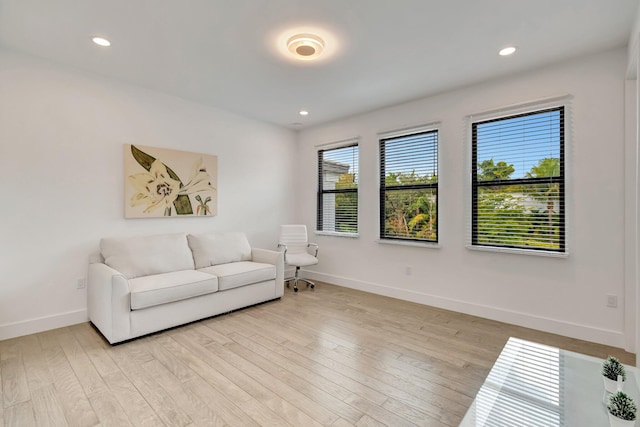 living room with baseboards, light wood-style floors, and recessed lighting