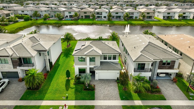 birds eye view of property featuring a water view and a residential view