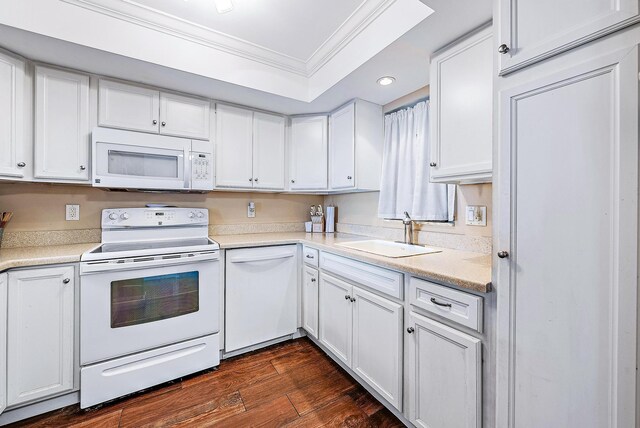 kitchen with ornamental molding, white appliances, recessed lighting, white cabinetry, and a sink