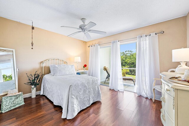 bedroom with baseboards, a ceiling fan, dark wood-style floors, and access to exterior