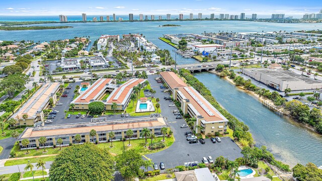 birds eye view of property featuring a city view and a water view