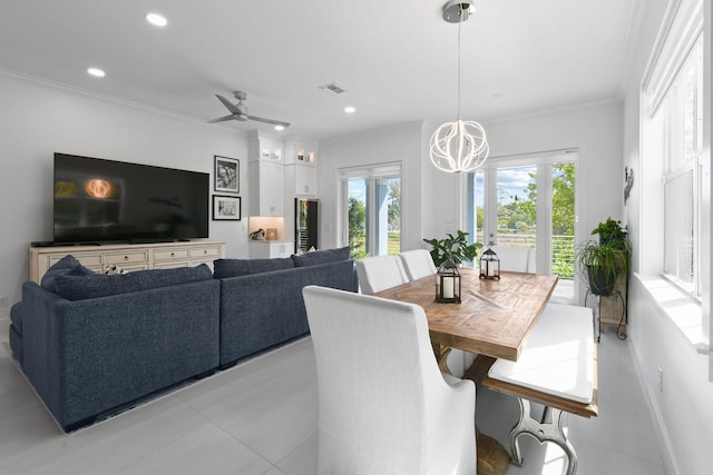 4707 SE Manatee Way, Stuart, FL 34997 - dining room featuring plenty of natural light, ornamental molding, ceiling fan with notable chandelier, and visible vents