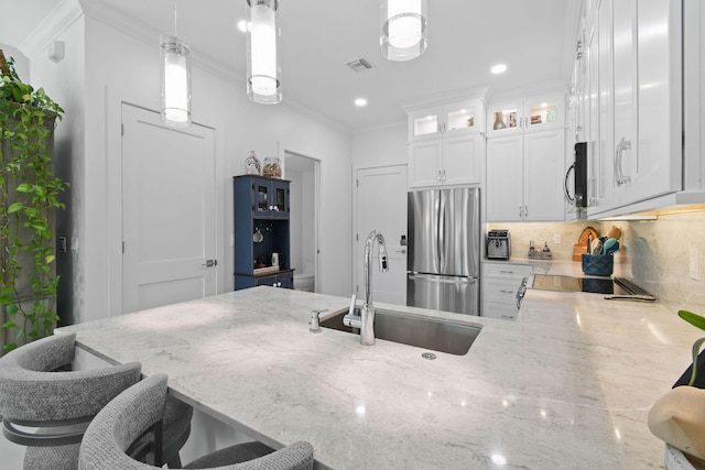 4707 SE Manatee Way, Stuart, FL 34997 - kitchen featuring visible vents, crown molding, light stone counters, a sink, and appliances with stainless steel finishes