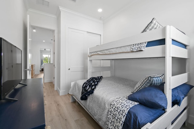 4707 SE Manatee Way, Stuart, FL 34997 - bedroom featuring light wood-style floors, recessed lighting, visible vents, ornamental molding, and a closet