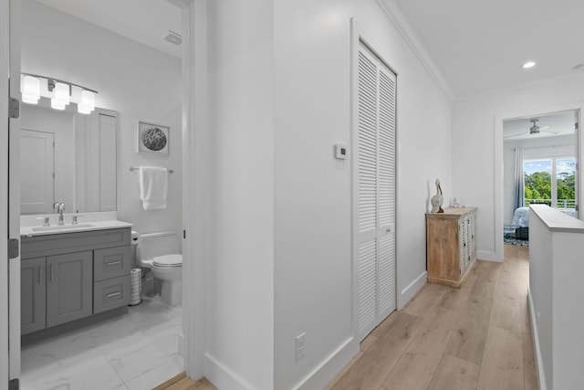 4707 SE Manatee Way, Stuart, FL 34997 - corridor with baseboards, a sink, recessed lighting, and ornamental molding