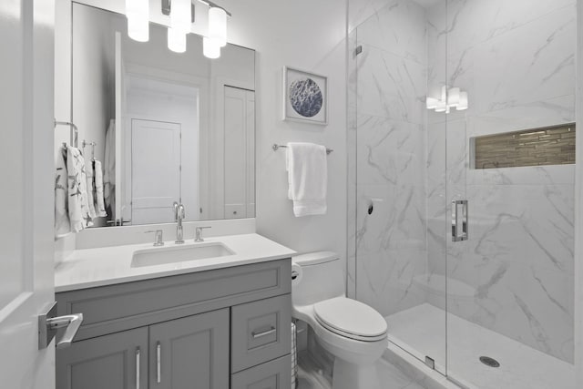 4707 SE Manatee Way, Stuart, FL 34997 - bathroom featuring a marble finish shower, vanity, and toilet