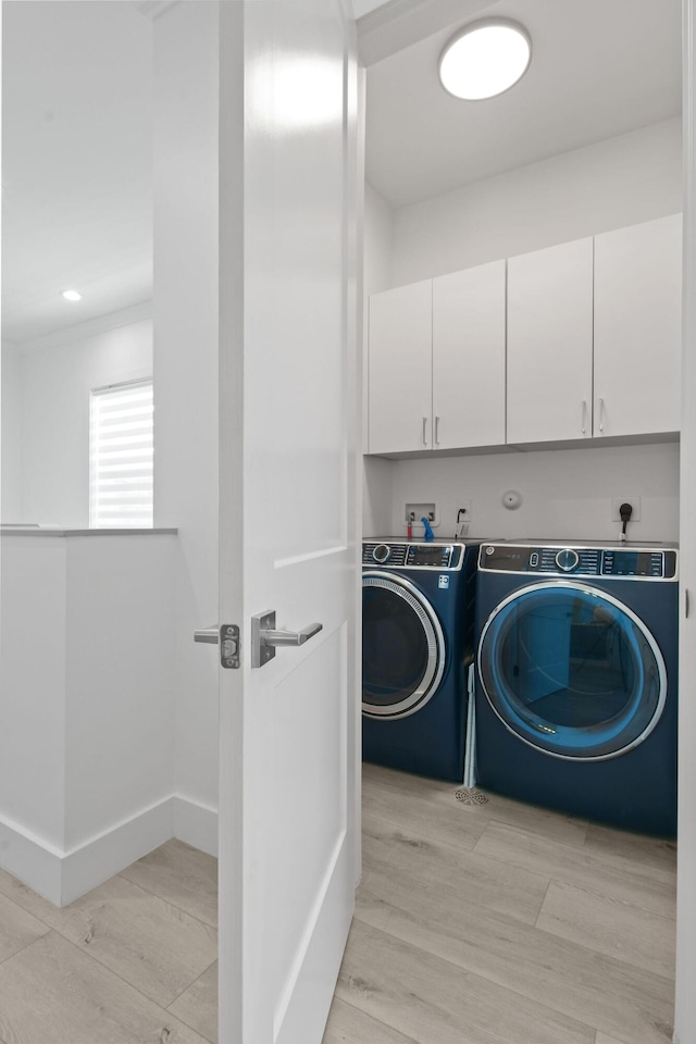 4707 SE Manatee Way, Stuart, FL 34997 - laundry room featuring baseboards, cabinet space, light wood finished floors, and independent washer and dryer