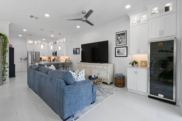 4707 SE Manatee Way, Stuart, FL 34997 - living room with ceiling fan, visible vents, beverage cooler, ornamental molding, and recessed lighting