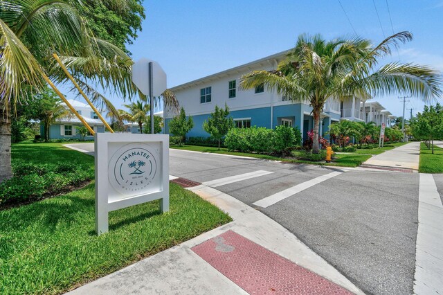 4707 SE Manatee Way, Stuart, FL 34997 - exterior space featuring traffic signs and sidewalks