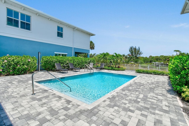 4707 SE Manatee Way, Stuart, FL 34997 - community pool with fence and a patio area