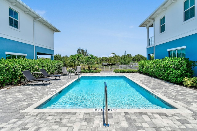 4707 SE Manatee Way, Stuart, FL 34997 - community pool with fence and a patio area