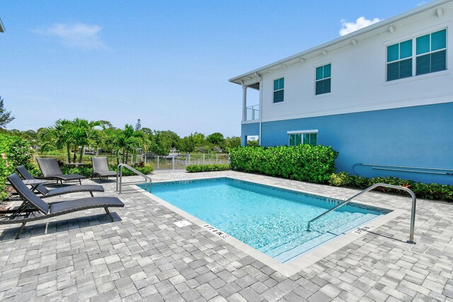 4707 SE Manatee Way, Stuart, FL 34997 - community pool featuring a patio and fence