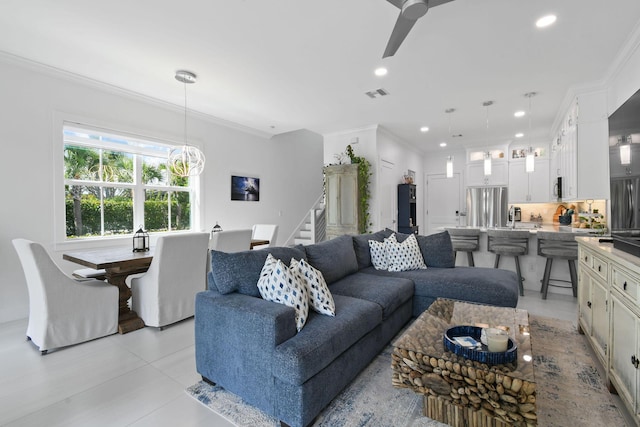 4707 SE Manatee Way, Stuart, FL 34997 - living area featuring visible vents, crown molding, ceiling fan with notable chandelier, and stairway