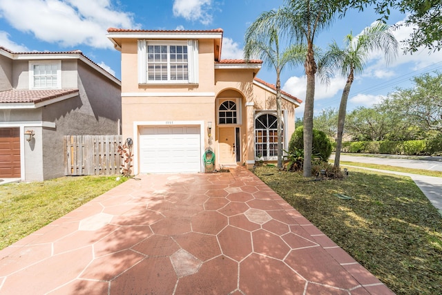 7997 Lakewood Cove Ct, Lake Worth, FL 33467 - mediterranean / spanish house featuring a tiled roof, driveway, a garage, fence, and stucco siding