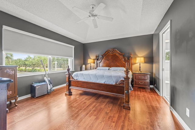 7997 Lakewood Cove Ct, Lake Worth, FL 33467 - bedroom with baseboards, a textured ceiling, ceiling fan, and wood finished floors