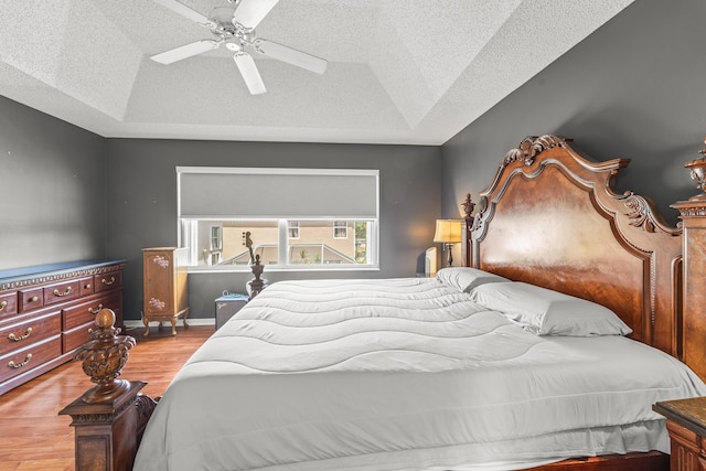 7997 Lakewood Cove Ct, Lake Worth, FL 33467 - bedroom with wood finished floors, baseboards, a textured ceiling, a ceiling fan, and vaulted ceiling