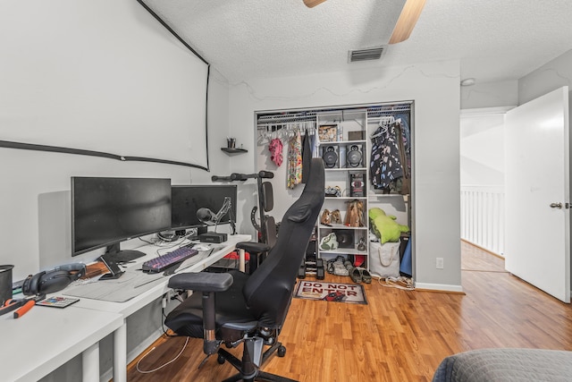 7997 Lakewood Cove Ct, Lake Worth, FL 33467 - office area featuring visible vents, a textured ceiling, ceiling fan, and wood finished floors