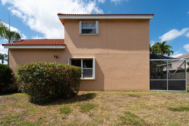 7997 Lakewood Cove Ct, Lake Worth, FL 33467 - rear view of property with a yard, a lanai, and stucco siding