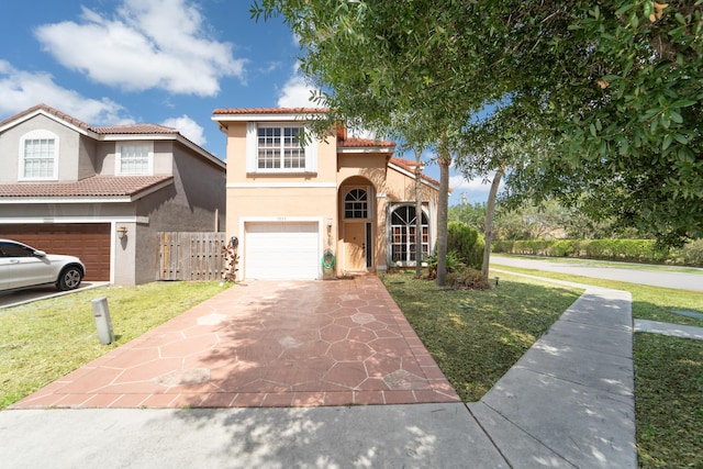 7997 Lakewood Cove Ct, Lake Worth, FL 33467 - mediterranean / spanish home with a garage, stucco siding, a tile roof, and a front yard