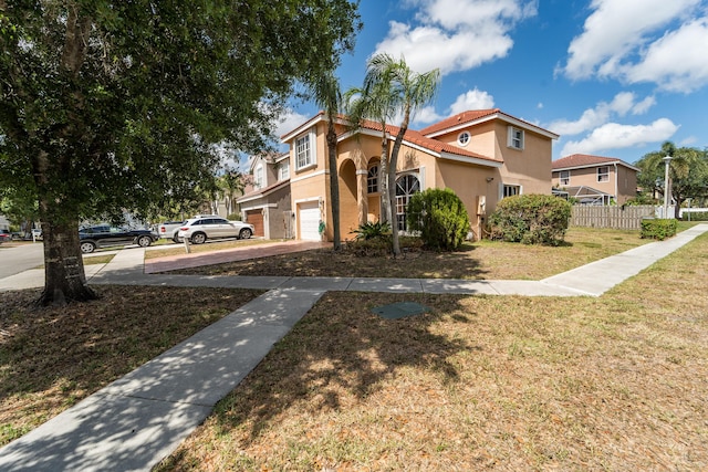 7997 Lakewood Cove Ct, Lake Worth, FL 33467 - mediterranean / spanish home with a garage, a front lawn, fence, stucco siding, and concrete driveway