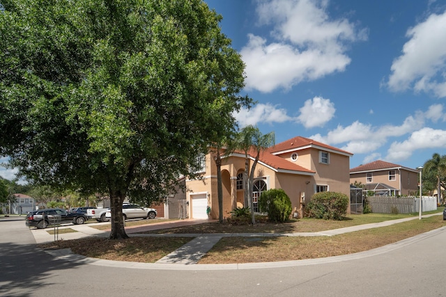 7997 Lakewood Cove Ct, Lake Worth, FL 33467 - mediterranean / spanish house featuring fence, stucco siding, an attached garage, and driveway