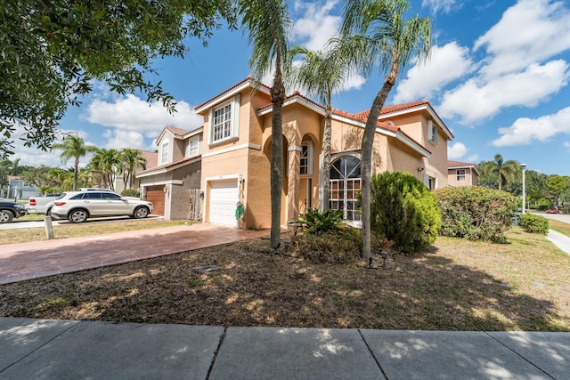 7997 Lakewood Cove Ct, Lake Worth, FL 33467 - mediterranean / spanish-style home featuring an attached garage, stucco siding, driveway, and a tile roof