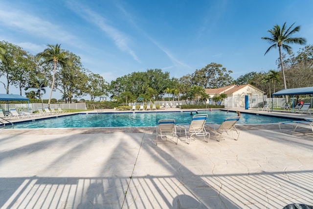 7997 Lakewood Cove Ct, Lake Worth, FL 33467 - community pool featuring a patio and fence