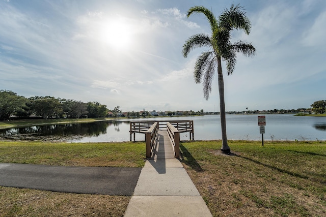 7997 Lakewood Cove Ct, Lake Worth, FL 33467 - dock area featuring a lawn and a water view