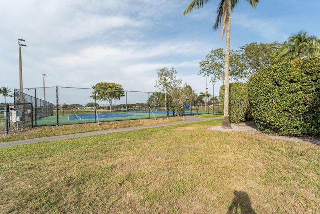 7997 Lakewood Cove Ct, Lake Worth, FL 33467 - view of home's community with a lawn, a tennis court, and fence