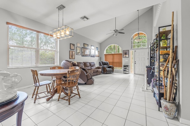7997 Lakewood Cove Ct, Lake Worth, FL 33467 - dining area featuring visible vents, light tile patterned floors, high vaulted ceiling, baseboards, and ceiling fan with notable chandelier