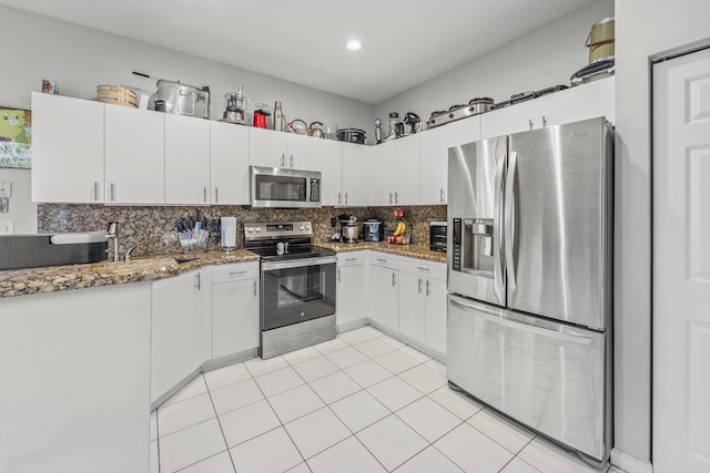 7997 Lakewood Cove Ct, Lake Worth, FL 33467 - kitchen featuring stainless steel appliances, decorative backsplash, light tile patterned flooring, and white cabinetry