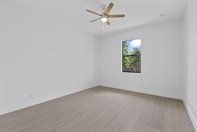 4665 SW Keats St, Port Saint Lucie, FL 34953 - empty room featuring ceiling fan, baseboards, and wood finished floors