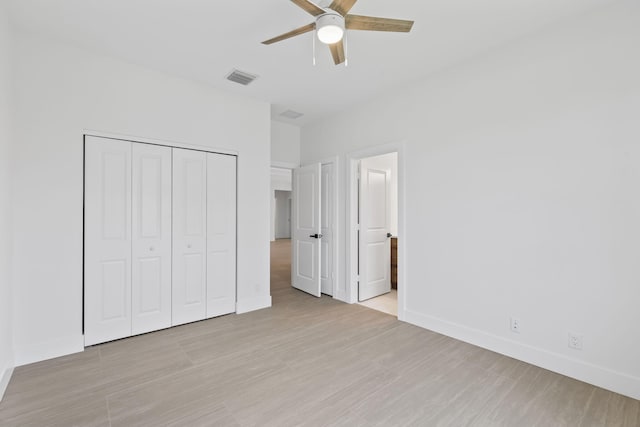 4665 SW Keats St, Port Saint Lucie, FL 34953 - unfurnished bedroom featuring baseboards, a closet, light wood-type flooring, a ceiling fan, and connected bathroom