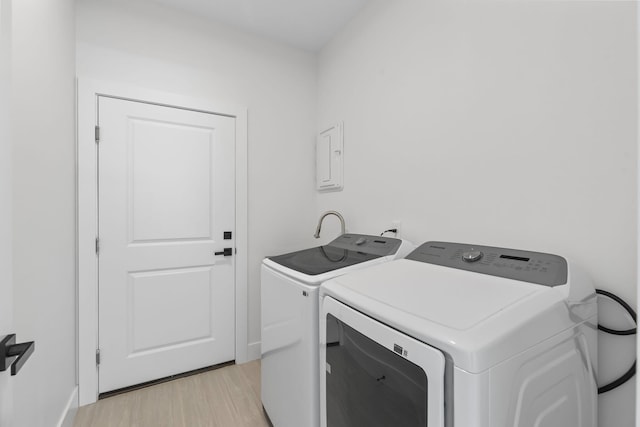 4665 SW Keats St, Port Saint Lucie, FL 34953 - laundry area featuring separate washer and dryer, light wood-style floors, and baseboards
