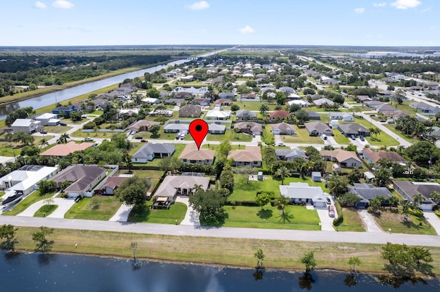4665 SW Keats St, Port Saint Lucie, FL 34953 - aerial view of property and surrounding area featuring nearby suburban area and a large body of water