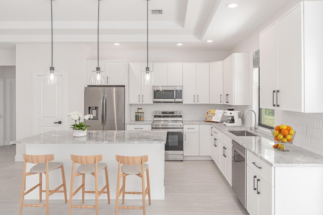 4665 SW Keats St, Port Saint Lucie, FL 34953 - kitchen featuring stainless steel appliances, a breakfast bar area, recessed lighting, a center island, and decorative backsplash
