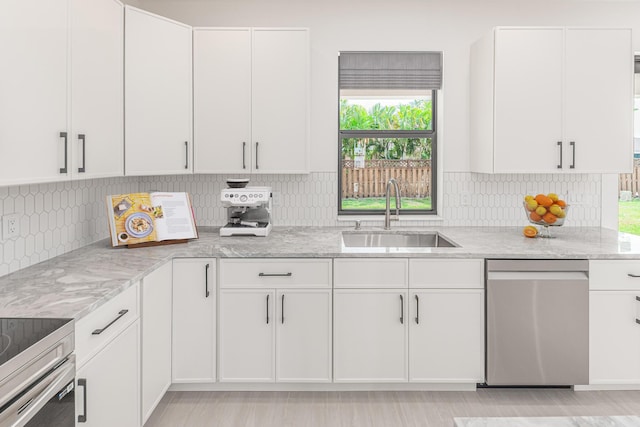 4665 SW Keats St, Port Saint Lucie, FL 34953 - kitchen with appliances with stainless steel finishes, light stone counters, and white cabinets