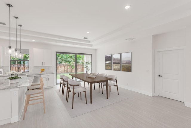 4665 SW Keats St, Port Saint Lucie, FL 34953 - dining space featuring light wood-type flooring, recessed lighting, and a raised ceiling