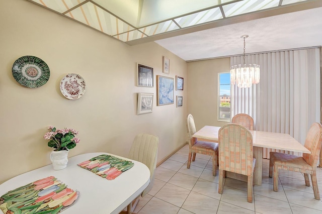 dining area featuring light tile patterned flooring and a notable chandelier