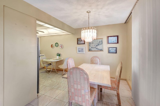 dining space featuring light tile patterned flooring and a notable chandelier