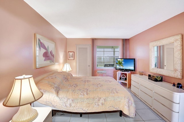 bedroom with a closet and light tile patterned flooring