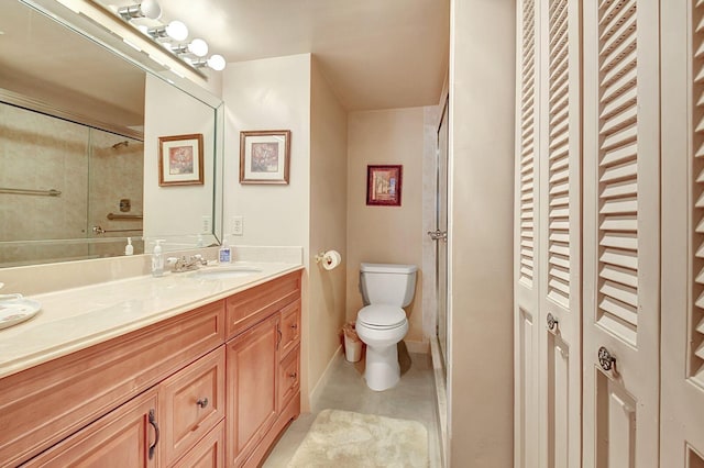 full bathroom with toilet, a shower with shower door, and vanity