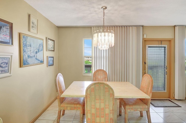 dining space featuring baseboards, an inviting chandelier, and light tile patterned floors