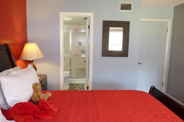 bedroom featuring ensuite bathroom and visible vents