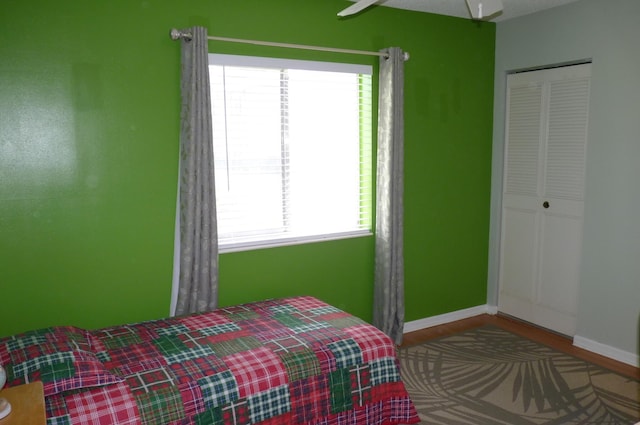 bedroom featuring baseboards and wood finished floors