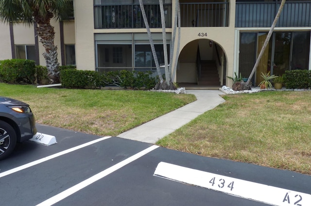 exterior space with uncovered parking and stucco siding