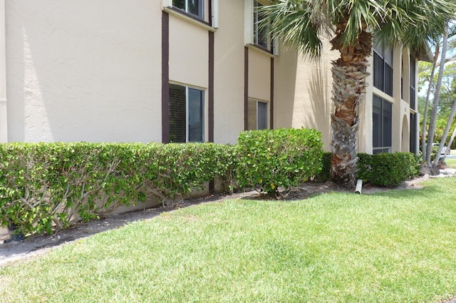 exterior space with a yard and stucco siding