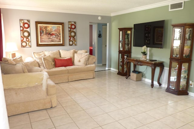living room with baseboards, visible vents, ornamental molding, and light tile patterned floors