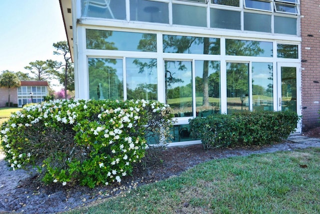view of side of home with brick siding