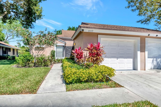 8449 Springlake Dr, Boca Raton, FL 33496 - single story home with stucco siding, concrete driveway, and a front lawn